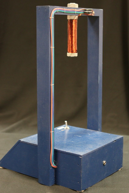 The magnet's hook-up wires are secured to the back of the support frame.
