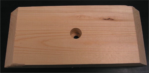 The base's back board had been cut and a hole for the power jack has been drilled through it.